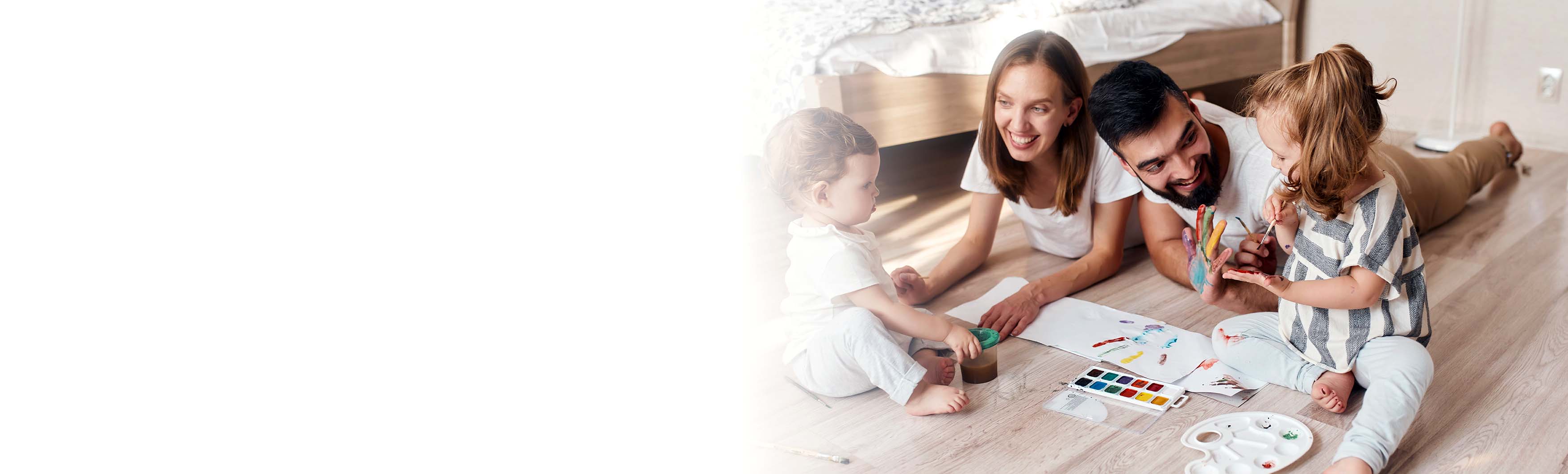 family on the floor painting with watercolors